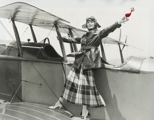 aviatrix on biplane with glass of red wine